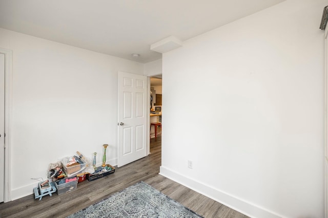 interior space with wood finished floors and baseboards