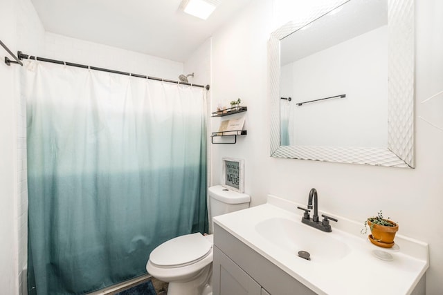 bathroom featuring curtained shower, toilet, and vanity