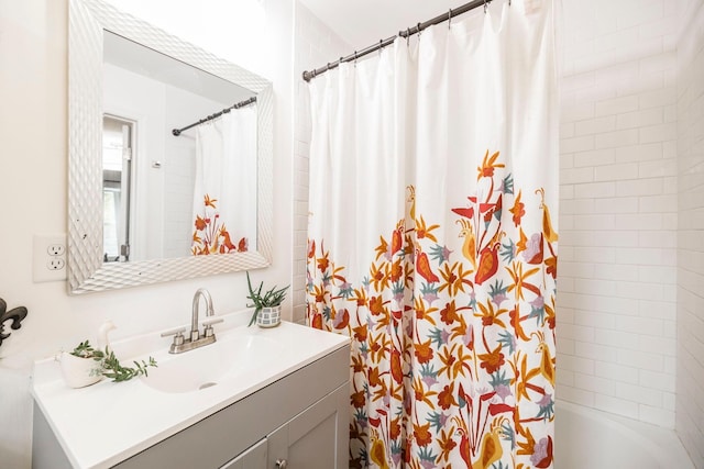 full bathroom featuring vanity and shower / bath combo with shower curtain