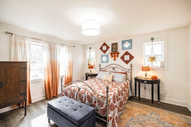 bedroom with baseboards and wood finished floors