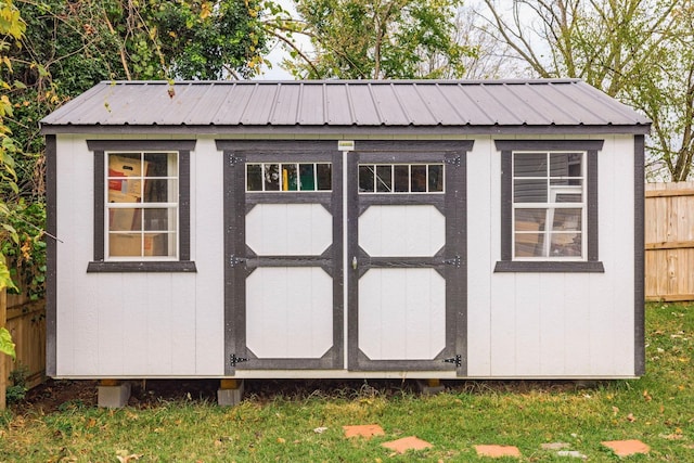 view of shed featuring fence