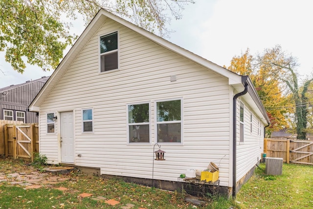 back of house featuring central air condition unit