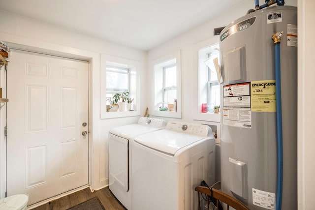 laundry area with laundry area, water heater, dark wood-style flooring, and washer and clothes dryer