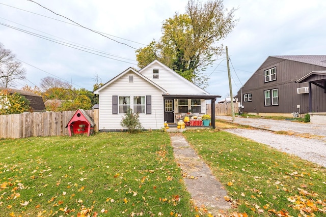 bungalow-style house with covered porch and a front yard