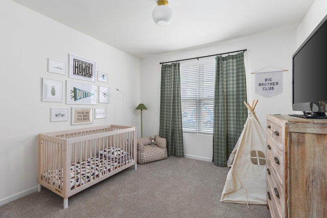 bedroom featuring carpet flooring and a crib