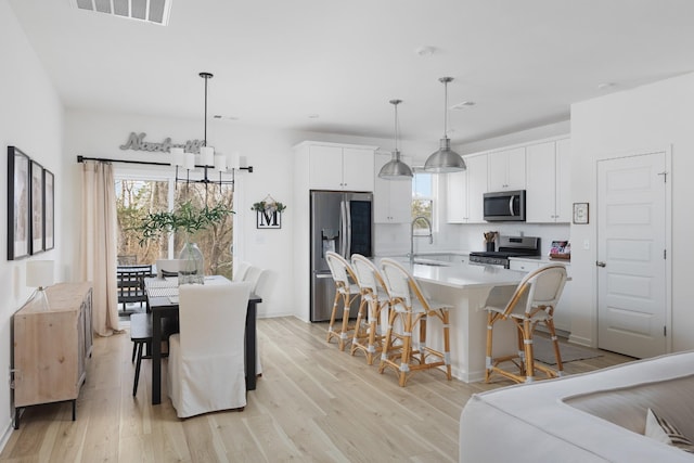 dining space featuring light hardwood / wood-style floors and sink