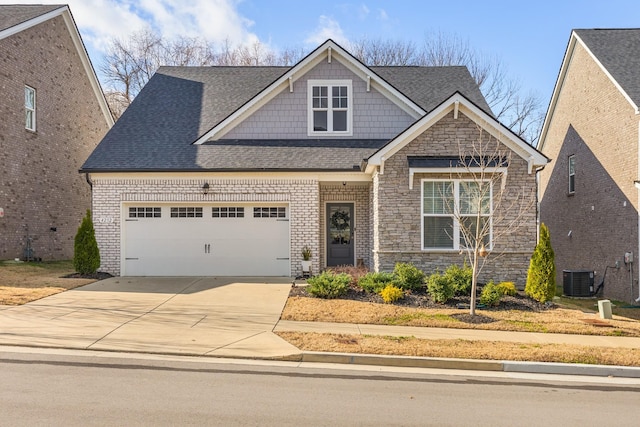 view of front of property featuring central AC unit and a garage