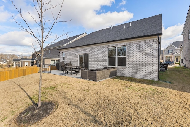 rear view of property with outdoor lounge area, a patio area, and a yard