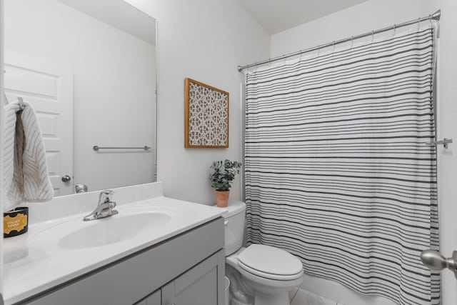 bathroom featuring vanity, curtained shower, and toilet