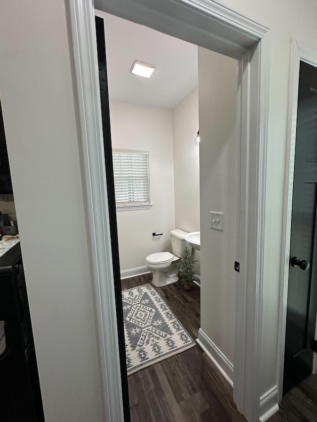 bathroom with vanity, toilet, and hardwood / wood-style flooring