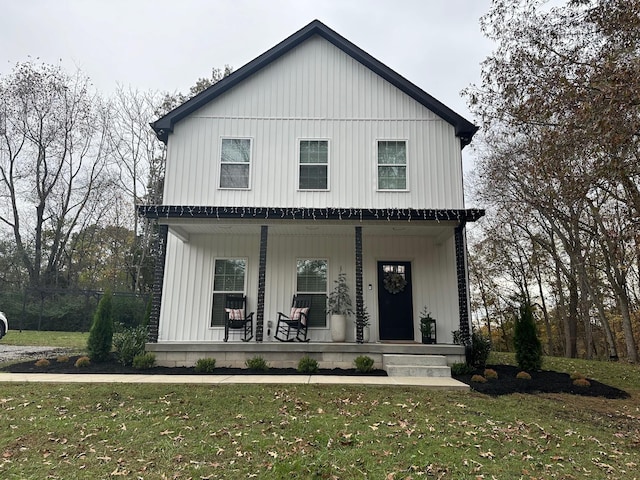 modern inspired farmhouse featuring a front yard and covered porch