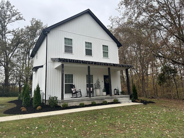 modern farmhouse style home with a front lawn and a porch