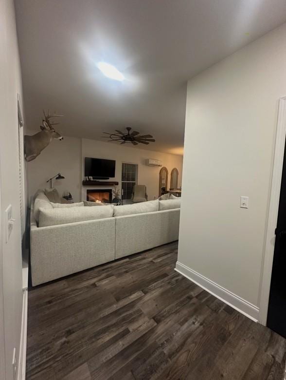 unfurnished living room with ceiling fan and dark hardwood / wood-style floors