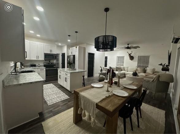 dining area with sink and dark hardwood / wood-style flooring