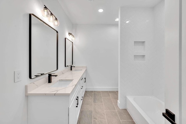 bathroom featuring tile patterned flooring, vanity, and a bath