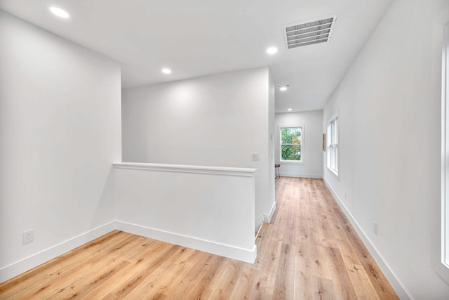 corridor with light wood-type flooring