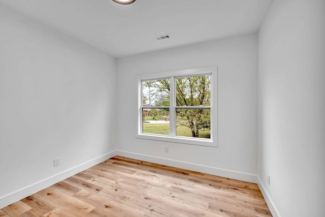 empty room with light hardwood / wood-style flooring