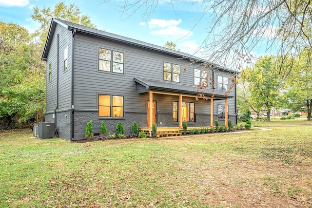 view of front of property with a front lawn and central air condition unit