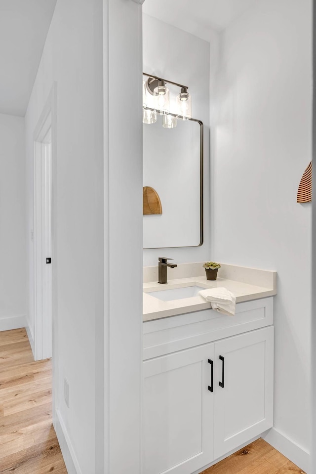 bathroom with hardwood / wood-style flooring and vanity