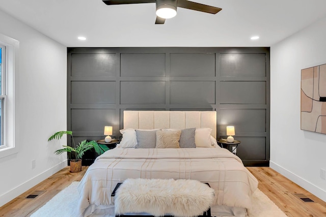 bedroom with ceiling fan and light hardwood / wood-style floors