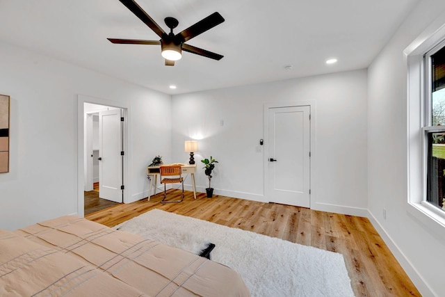 bedroom with ceiling fan and light hardwood / wood-style flooring