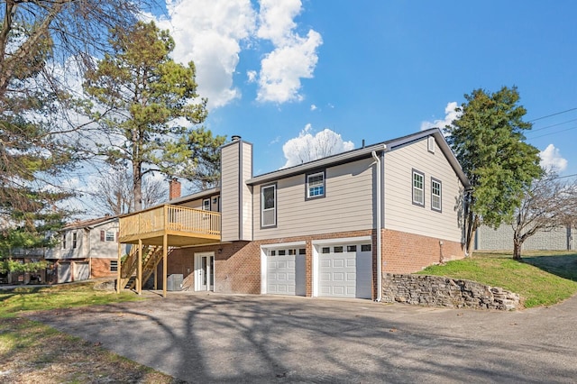 view of front of house featuring a wooden deck, central AC, and a garage