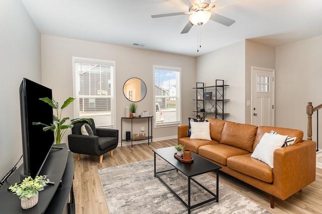 living room with ceiling fan and light hardwood / wood-style floors