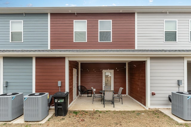 rear view of property featuring central AC and a patio area