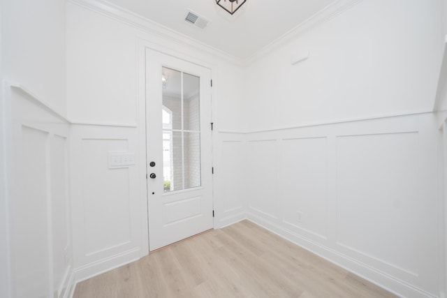 entryway featuring crown molding and light hardwood / wood-style flooring