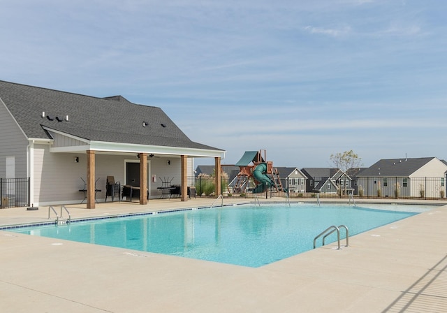 view of swimming pool featuring a patio area and a water slide