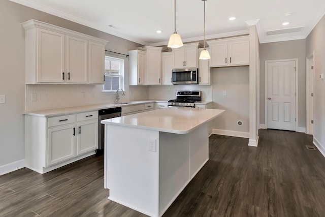 kitchen featuring white cabinetry, sink, stainless steel appliances, dark hardwood / wood-style floors, and a kitchen island