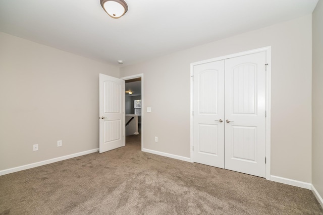 unfurnished bedroom with light carpet and a closet