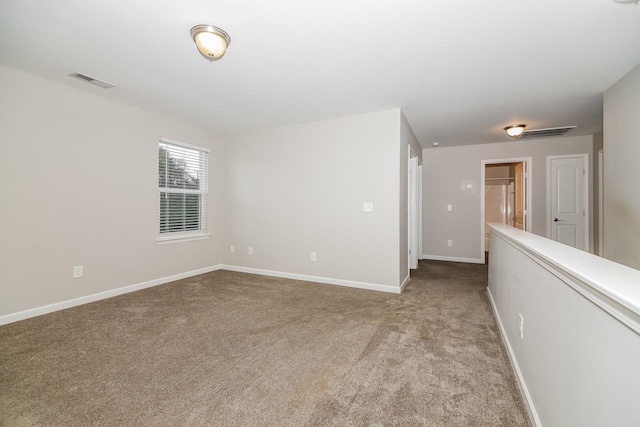 unfurnished room featuring light colored carpet