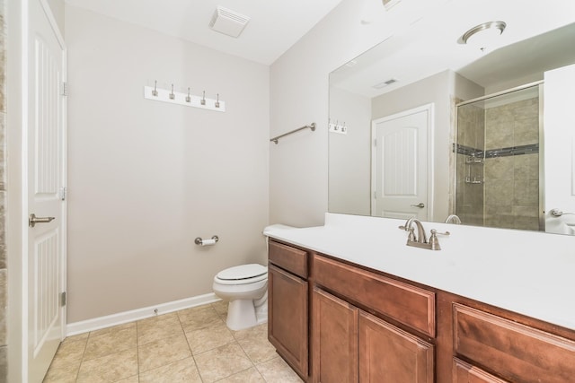 bathroom featuring tile patterned flooring, vanity, a shower with shower door, and toilet