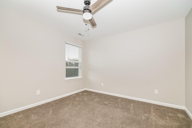 carpeted spare room featuring ceiling fan