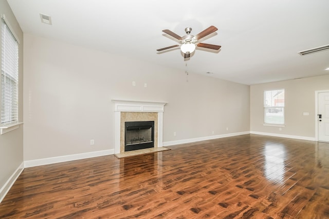 unfurnished living room featuring ceiling fan and dark wood-type flooring