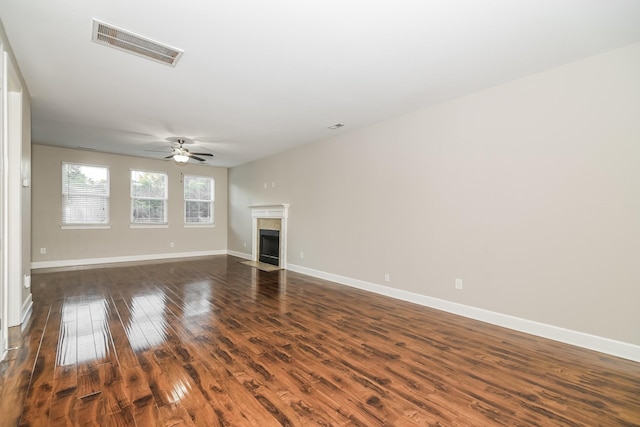 unfurnished living room with ceiling fan and dark wood-type flooring