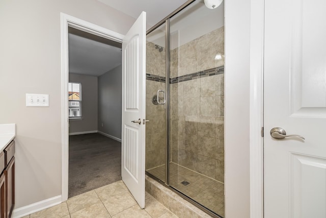 bathroom featuring vanity, tile patterned floors, and a shower with door