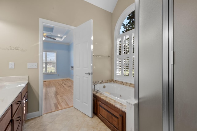 bathroom featuring tile patterned flooring, a bath, vanity, and ceiling fan