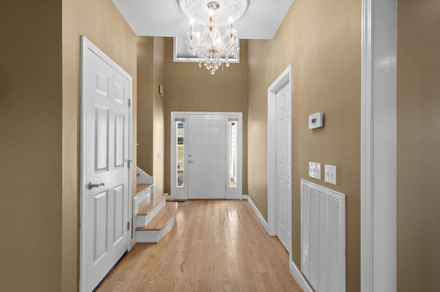 foyer featuring a chandelier and light wood-type flooring