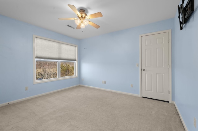 carpeted empty room with ceiling fan