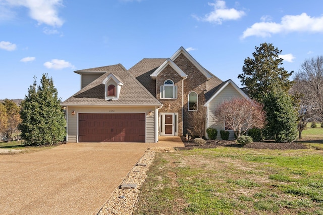 front of property featuring a front yard and a garage