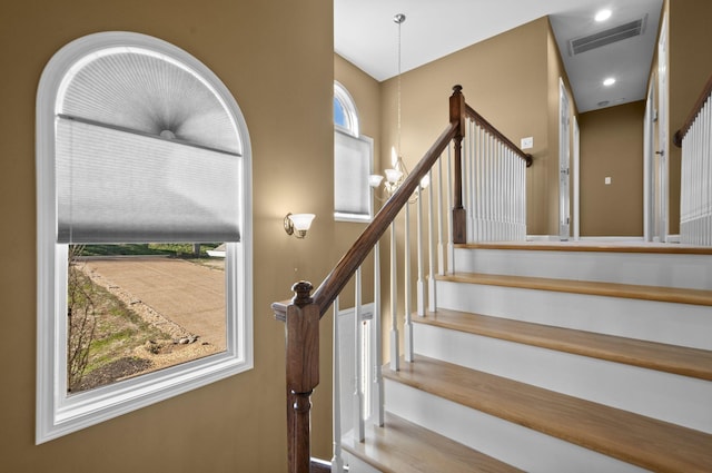 stairway with an inviting chandelier