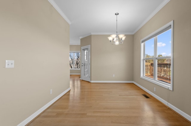 unfurnished dining area with ornamental molding, a wealth of natural light, and a chandelier