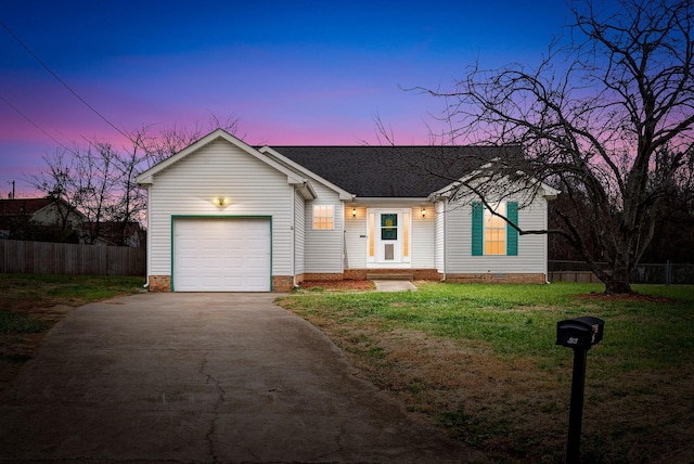 single story home featuring a lawn and a garage