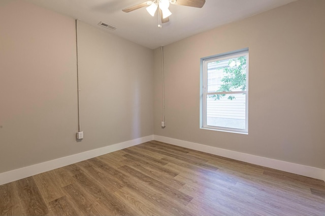 spare room with light hardwood / wood-style flooring and ceiling fan