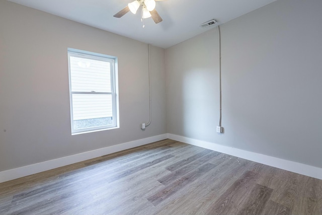 empty room featuring ceiling fan and light hardwood / wood-style flooring