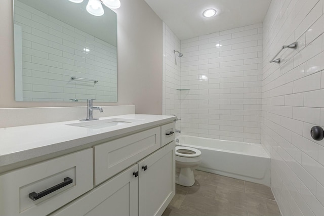 full bathroom featuring tile patterned flooring, vanity, toilet, and tiled shower / bath