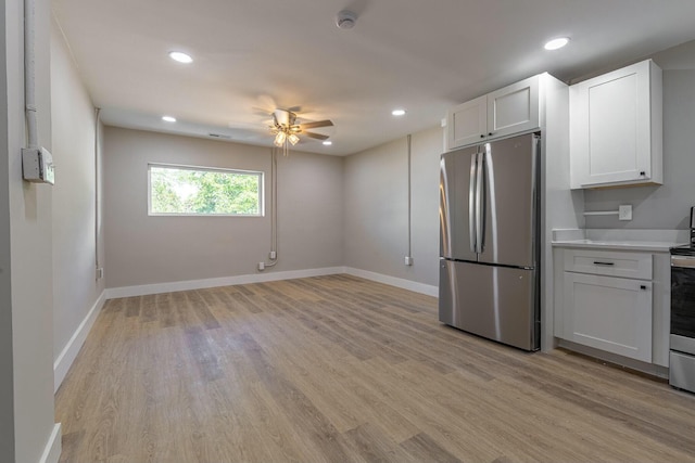 kitchen featuring white cabinets, stainless steel appliances, light hardwood / wood-style flooring, and ceiling fan