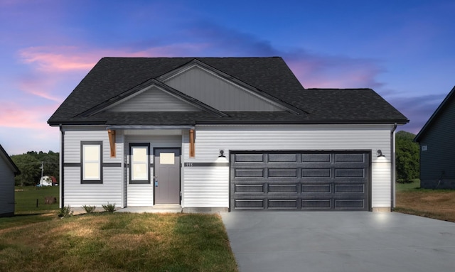 view of front of home with a lawn and a garage